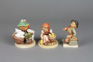 A Hummel figure of a boy with 3 white rabbits 58/0 4 1/2" (f), a ditto of a girl with chicks 57/0 (f) 3 1/2" and a boy with umbrella 11 2/0 4" (f)