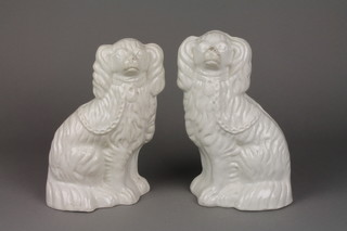 A pair of Victorian white glazed Staffordshire Spaniels 9" 