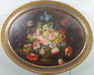 20th Century oil painting, a still life study of a repousse bowl of spring flowers, unsigned, oval, 29" x 37" in a fancy painted gilt frame