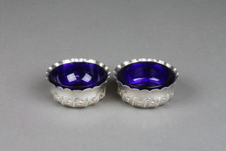 A pair of repousse silver salts with later liners, Birmingham 1919