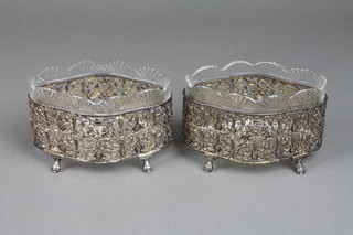 A pair of Victorian quatrefoil silver centerpieces with cut glass bowls, the pierced decoration with cherubs amongst scrolls on acanthus feet, London 1887, foreign import mark, approx 184 grams