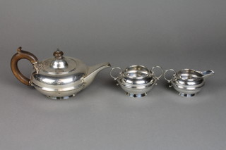 A bachelors silver  tea set of squat baluster form with fruitwood mounts, London 1921, approx. 317 grams gross