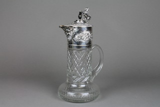 A Victorian silver mounted claret jug with lion finial and repousse vinous decoration and masks on a later cut glass body, London 1859 (f)