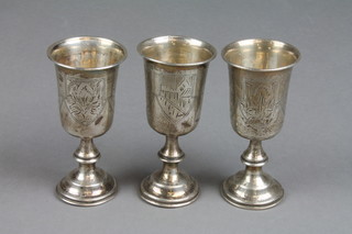 A set of 3 19th Century silver Kiddush cups, the chased decoration with street scenes 5"  