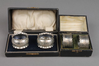 A matched pair of cased silver napkin rings, a ditto pair, approx. 96 grams
