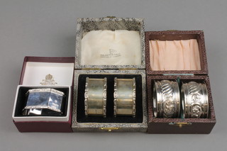 A cased pair of Edwardian repousse silver napkin rings Birmingham 1908, 1 other cased pair and a single ditto, approx 90 grams