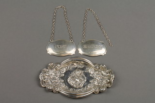 A repousse silver pin tray with cherub and floral decoration, London 1990, 2 silver spirit labels, approx. 50 grams
