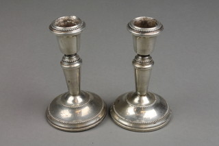 A pair of dwarf silver candlesticks of tapered form with beaded decoration 4 1/2" Birmingham 1979