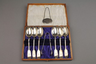 A cased set of silver teaspoons and nips, a ditto spirit label