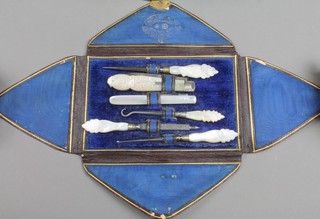 A cased set of mother of pearl mounted manicure tools including a silver and mother of pearl fruit knife