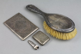 A silver vesta with chased decoration, a silver backed brush, a cigar cutter and an Arab white metal card case