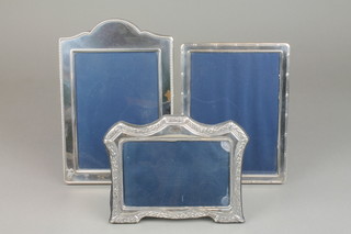 A rectangular silver photo frame 8" x 6" and 2 others 