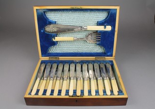 A set of silver plated engraved fish eaters for 12, with servers, contained in a fitted mahogany canteen