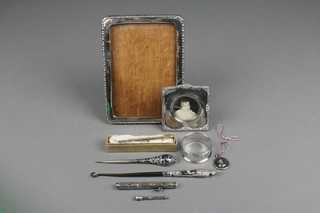 A rectangular silver photo frame 6" x 4 1/2", 1 other, a napkin ring and 6 other items