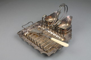 A silver plated asparagus set comprising tray with rack and 2 sauce boats with scroll handles, together with a server