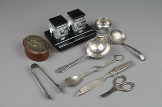 A silver tea strainer with fancy handle Sheffield 1961, ditto napkin ring, minor cutlery and an Art Deco ink stand