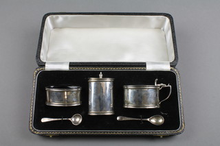 A silver 3 part condiment set with blue glass liners and matched spoons, Birmingham 1969, approx. 146 grams