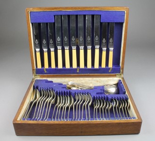 A canteen of plated cutlery in a fitted oak canteen