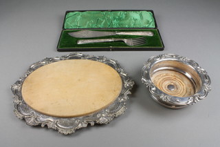 A pair of cased plated fish servers, a ditto coaster and mounted bread board