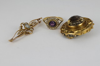An antique 15ct gold Etruscan citrine brooch, a 15ct gold aquamarine and pearl  bar brooch and an 18ct gold amethyst and pearl cluster ring