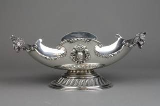 A Spanish silver boat shaped fruit bowl with vineous handles and portrait masks on a demi-fluted base, approx. 142 grams