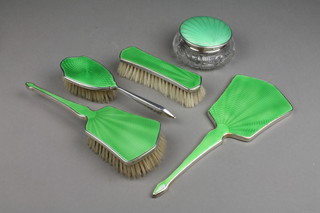 A 1930's silver and green guilloche enamel 4 piece brush set, a similar cut glass powder bowl