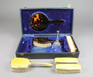 A 1930's silver yellow guilloche enamelled brush set, a cased faux tortoiseshell ditto and a hand bell