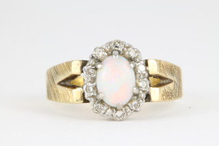 An 18ct yellow gold opal and diamond cluster ring with open shank