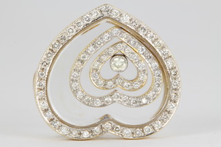 An 18ct diamond set heart shaped pendant enclosing 2 graduated diamond set hearts and a brilliant cut stone