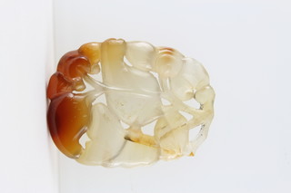 A Chinese carved hardstone pendant in the form of flowering fruits