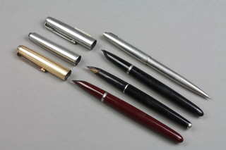 A burgundy and gilt Parker fountain pen, 2 others and a ball pen 