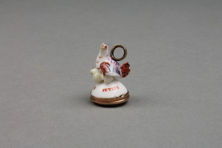 A 19th Century porcelain seal in the form of a hen and chicks with a hardstone cut intaglio