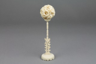 A Cantonese carved ivory concentric ball on a ditto stand with pierced base 7" 