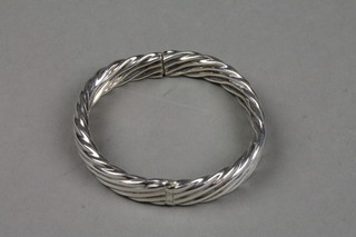 A silver hollow spiral bangle 
