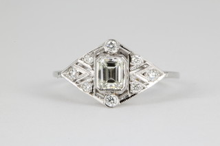 An 18ct white gold Art Deco style diamond ring, the centre cut rectangular stone approx. 0.4ct surrounded by 8 brilliant cut diamonds, approx. 0.3ct