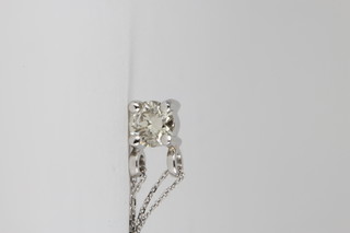 An 18ct white gold claw set diamond pendant, approx. 0.4ct on a ditto chain