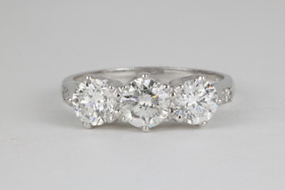 An 18ct white gold claw set 3 stone diamond ring, approx. 1.80ct