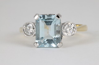 An 18ct yellow gold aquamarine and 3 stone diamond ring, the centre aquamarine approx. 2ct, flanked by single diamonds each approx. 0.25ct