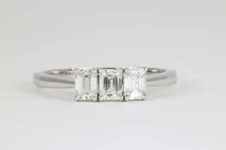 An 18ct white gold baguette cut 3 stone diamond ring, approx. 0.9ct 