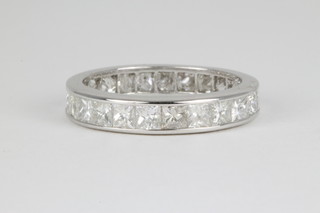 An 18ct white gold diamond eternity ring set with 23 princess cut stones, approx. 3.10ct 