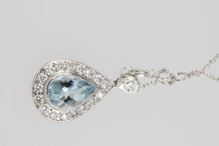 An 18ct white gold aquamarine and diamond pear shaped pendant supported by a brilliant cut stone, the aquamarine approx. 1.5ct surrounded by 17 brilliant cut diamonds approx. 0.6ct