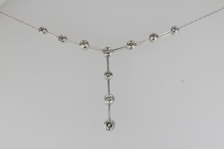 An 18ct white gold diamond set necklace with 10 rub over set diamonds, approx. 1.75ct