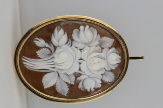 A carved cameo brooch of spring flowers in a 14ct gold mount 
