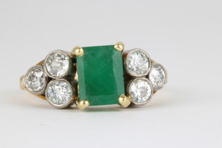An 18ct yellow gold emerald and diamond ring, the centre rectangular cut emerald flanked by 3 brilliant cut diamonds