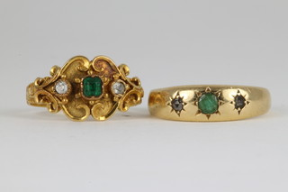An 18ct emerald and diamond gypsy set ring, a 19th Century ditto