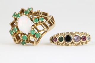 A 9ct gold gemset "Regard" ring, a 9ct gold opal and emerald ditto 