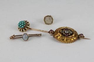 An antique gold and gem set Etruscan style brooch, a seal, tie pin and opal bar brooch