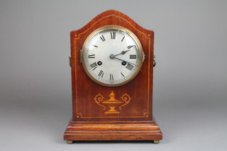 An Edwardian 8 day striking bracket clock with silvered dial and Roman numerals contained in an inlaid mahogany arch shaped case