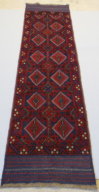 A Meshwani red ground runner with diamond design to the centre 103" x 25"