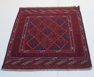A red and blue ground Tabriz rug with diamond design to the centre 54" x 43" 